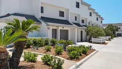 a house with trees and plants in front of it at Emerald Hill 12A in Santa Rosa Beach
