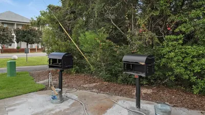 two electrical boxes sitting on the side of a yard at Mistral 10 in Seacrest