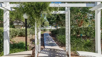a white pergola with a walkway at Beachwood Villas 4G in Santa Rosa Beach