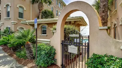 a gate to a building with a sign in front of it at Monterey Condos A302 in Panama City Beach