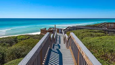 a stairway leading down to a beach with the ocean at Blue Nine 9 in Panama City Beach