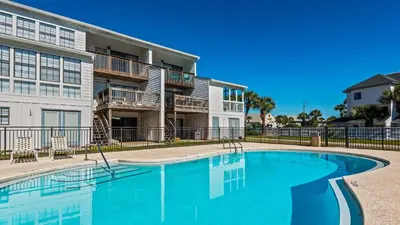 a swimming pool in front of a apartment building at Beachside Condo 11 in Santa Rosa Beach