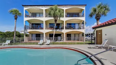 a hotel with a swimming pool in front of a building at Palms C11 in Santa Rosa Beach