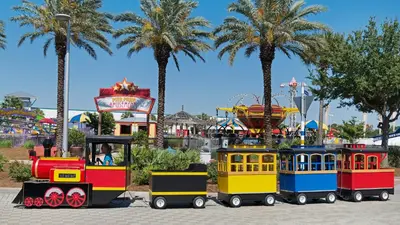 a train ride in a park with palm trees at Leo's Hideaway in Panama City Beach