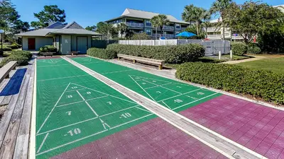 a painted football field with a bench and a house at Beachwood Villas 3A in Santa Rosa Beach
