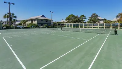 a tennis court with a person standing on it at Beachwood Villas 3A in Santa Rosa Beach