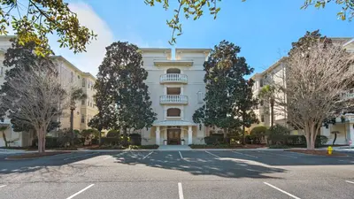 a large building with a parking lot in front of it at Villas At Seagrove B201 - Emerald Dunes in Santa Rosa Beach