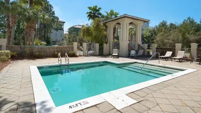 a swimming pool in a yard with a gazebo at Ocean Breeze in Santa Rosa Beach