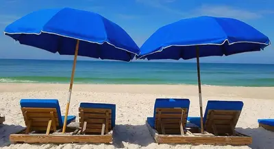 a group of chairs and umbrellas on a beach at Top of the Gulf 416 in Panama City Beach