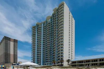a tall white building on the beach with buildings at Sterling Breeze 804 in Panama City Beach