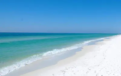 a beach with the ocean and a blue sky at Cassine Gardens 273- Kwitcherbeachin' in Santa Rosa Beach
