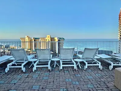 a group of chairs sitting on top of a roof at Stunning Resort Low Floor Condo! Sleeps 8! Steps 2 Beach & Restaurants! by Dolce Vita Getaways PCB in Panama City Beach