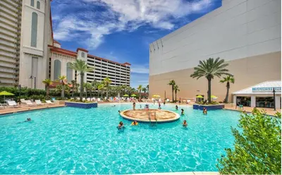 a pool at a resort with people in the water at Lovely Resort Low Floor Condo! Just Steps to the Beach & Restaurants! by Dolce Vita Getaways PCB in Panama City Beach