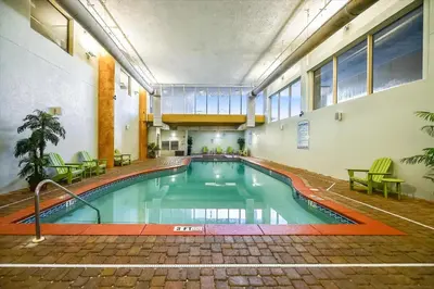 an indoor swimming pool in a building with tables and chairs at Shores of Panama 1206 - Amazing Studio, Free Fun! Sleeps 3, Romantic condo in Panama City Beach