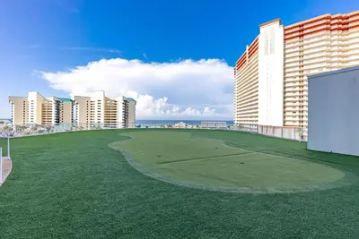 a golf course in the middle of a city with buildings at Spacious Beach Condo with Gulf Views! Sleeps 8! by Dolce Vita Getaways PCB in Panama City Beach
