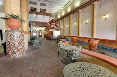 a lobby with tables and chairs and a pool at Shores of Panama 620-Sleeps 8, Free Fun! Reserved Parking Space! Updated! condo in Panama City Beach