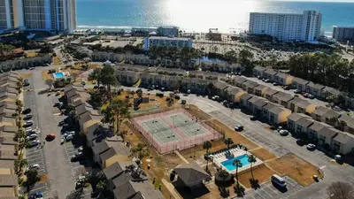 an aerial view of a city with a tennis court at Compass Cove at Gulf Highlands by Nautical Properties Vacation Rentals in Panama City Beach