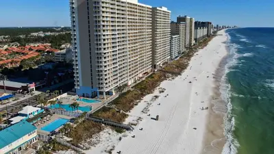 an aerial view of a beach and buildings at Compass Cove at Gulf Highlands by Nautical Properties Vacation Rentals in Panama City Beach