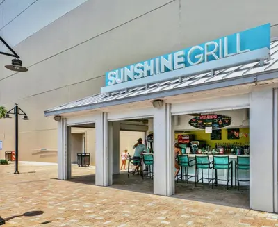 a sun shine grill sign on the side of a building at Stunning Ocean Views! Resort Beach Condo! Sleeps 8! by Dolce Vita Getaways PCB in Panama City Beach