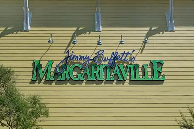 a neon sign on the side of a building at Charming Retreat, a Short Walk to Laguna Beach, with Room for 10! in Panama City Beach
