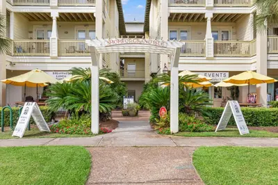 a hotel with a sign in front of a building at 24 York Lane | Edgewater Escape in Inlet Beach