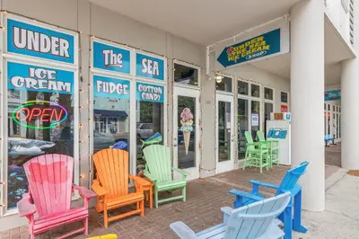 a group of colorful chairs outside of a store at Luxury Home in Palmeira Village w Private Pool, Steps to Beach for 12! in Santa Rosa Beach
