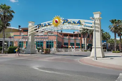 a large building with a large sign on a street at Emerald Beach Resort Condo-Gulf Front+Beach Access! Beach Chair Service! in Panama City Beach