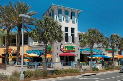 a building with tables and umbrellas in front of it at Aqua Resort 2108 - Beach Daze in Panama City Beach