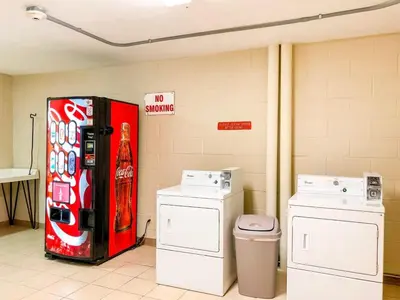 a soda machine in a room with two washing machines at Top Of The Gulf 704 in Panama City Beach