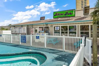 a restaurant with a pool in front of a building at The Summit 1123 in Panama City Beach