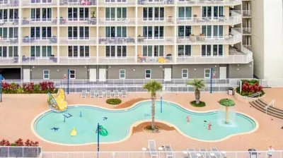 a large swimming pool in front of a building at Deep Blue at Laketown Wharf #214 by Nautical Properties in Panama City Beach