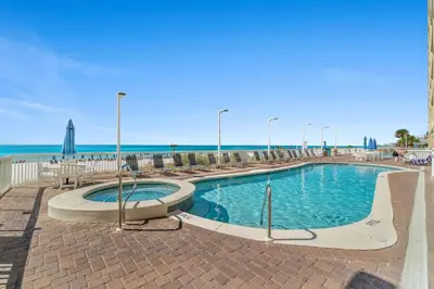 a swimming pool with the beach in the background at Seychelles #1007 in Panama City Beach
