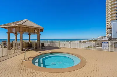 a hot tub with a gazebo next to the beach at Treasure Island #1005 in Panama City Beach