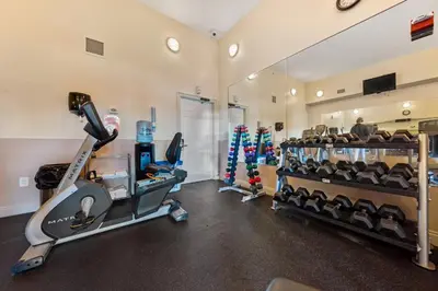 a gym with treadmills and cardio equipment in a room at Treasure Island #0110 in Panama City Beach