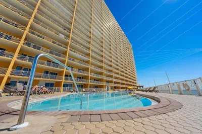 a large building with a swimming pool in front of it at Treasure Island #2007 in Panama City Beach