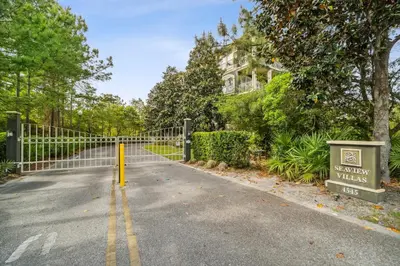 a road with a fence in front of a house at 30A Sea View Villas by Panhandle Getaways in Santa Rosa Beach