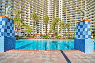 a swimming pool in front of a large apartment building at Shores of Panama 1802 in Panama City Beach